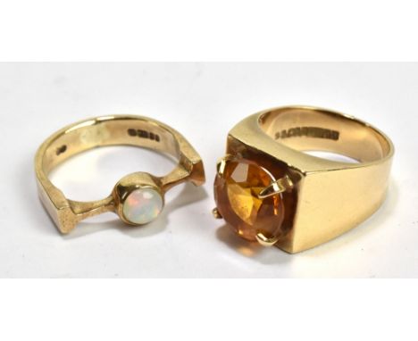 A 9ct yellow gold and opal set ring of abstract design, size H1/2, and a further 9ct yellow gold ring, size J, combined appro