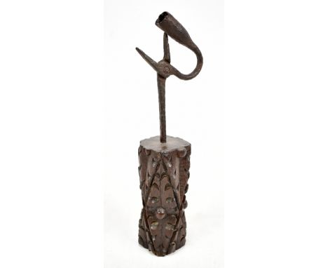 An 18th century wrought iron rush light mounted in a carved oak base, height 28cm (base possibly associated).