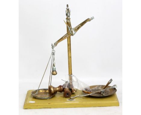 A set of brass chemist scales on painted wooden base, with maker's badge inscribed Falcon Hotel, Stratford-upon-Avon, height 