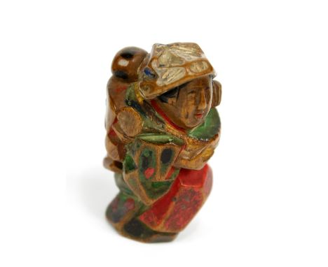 GYUKA; a 19th century Japanese carved wooden netsuke of a tea picker with child upon her back, signed, height 4cm.Additional 
