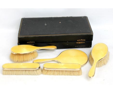 CHARLES HENRY DUMENIL; a cased George V hallmarked silver guilloche enamelled vanity set, London 1925 (af).Additional Informa