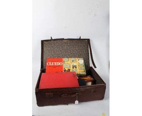 Brown leather case and contents of various 1950's onwards games, to include Cluedo (1965), Monopoly, Win-A-Lot, playing cards