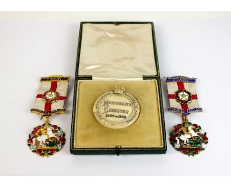 The Royal Society of St George silver gilt and polychrome enamel badge, together with a gilt example and an ivory Royal agric