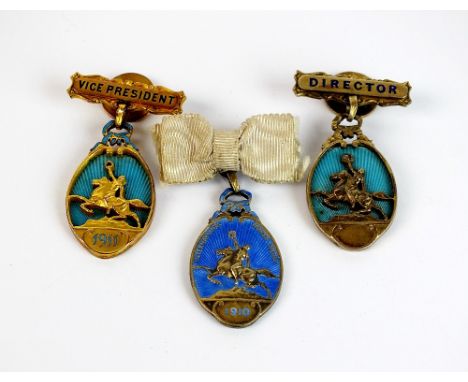 An International horse show director badge, set with a rose cut diamond, together with a silver gilt and enamel badge, dated 