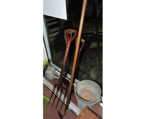A quantity of garden equipment to include oak handled fork, spade, and hoe, together with two pails and a watering can