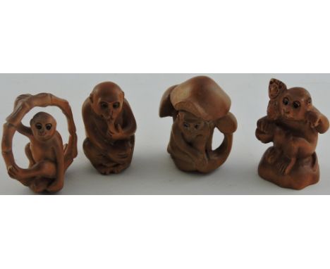 Four carved hardwood netsuke, modelled as cheeky monkeys