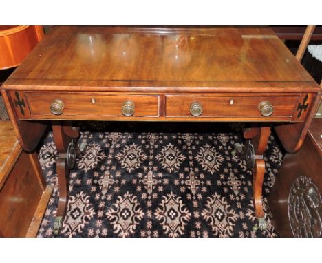 A William IV sofa table with two draws, on brass castors, extended: 144cm