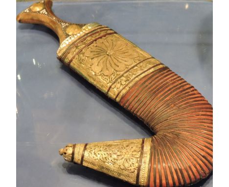 A Middle Eastern dagger in scabbard, decorated with metal filigree work and ribbed leather