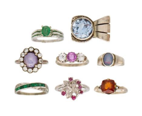 A selection of white metal rings. Including a bow-shaped ring with synthetic blue spinel, triplet opal signet, etc.Opal tripl