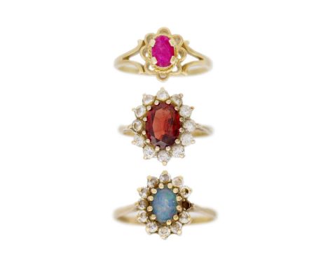 A selection of three 9k gem set rings. One is a ruby set ring, size O 1/2, one is an opal and CZ set cluster, size P, and ano