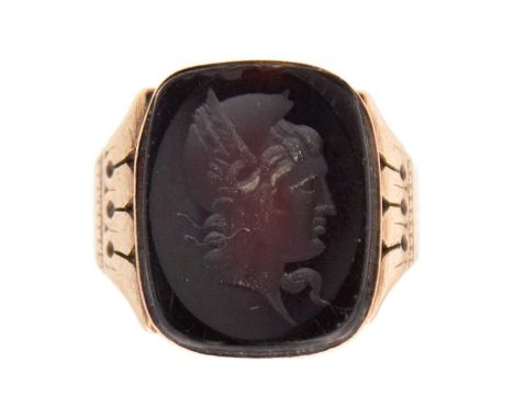A late Victorian high-purity gold garnet intaglio signet ring. Closed-back, engraved decoration on the shoulders, 1.6cm x 1.8