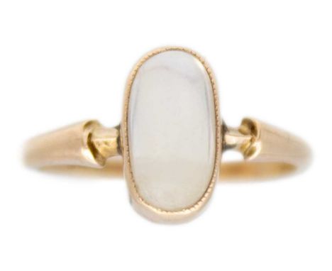 A 9ct gold moonstone solitaire ring. The elongated oval moonstone cabochon is 9 x 5mm, bezel set, stamped 9ct, ring size L1/2