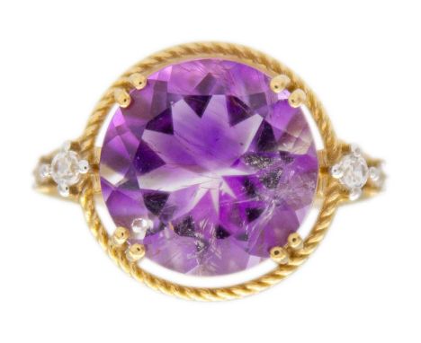 A 9k gold amethyst and zircon dress ring. The round mixed-cut amethyst is 12mm in diameter, set with two round zircons on eac