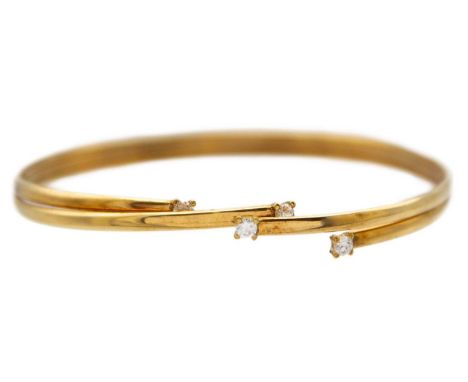 A modern 9k cz set bangle. Claw set with four round cut stones, Sheffield hallmark, 5.27g.