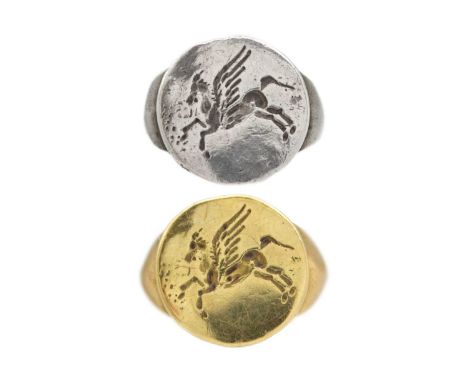 An 18k yellow gold signet ring and a matching silver ring. With a Pegasus engraving on both signet rings, the gold ring is st