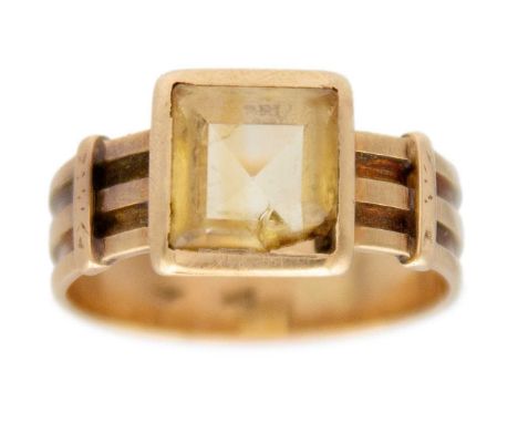 A golden citrine solitaire band ring in 14K yellow gold. The square, step-cut citrine, 7mm x 7mm, bezel set in a wide band sh