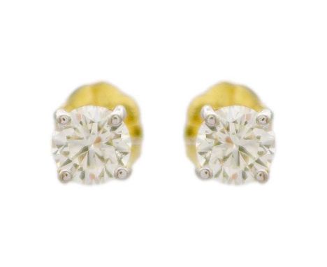 A pair of 18k round brilliant-cut diamond solitaire ear studs. The diamonds of 0.50ct estimated total weight, of uniform whit