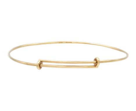 A Tiffany & Co 9k gold adjustable wire bangle. Diameter 7cm approx., stamped T&amp;Co, London hallmark, weight 5.32g.