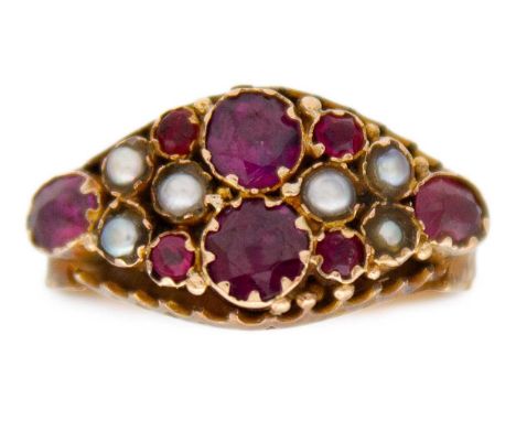 A Victorian 9k garnet, ruby, and split pearl set, closed-back ring. Decorative engravings on the shank, Chester hallmarked 37