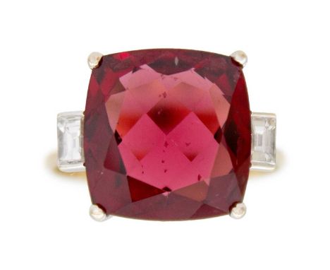 A Rhodolite garnet and diamond 18k gold dress ring. The square cushion-cut purplish red garnet is 12mm x 12mm, set with a bag