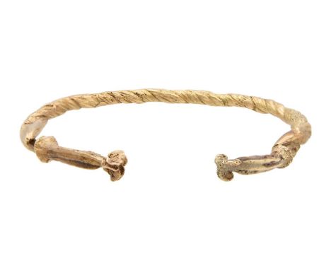 A yellow gold bangle, possibly ancient. Crafted with twisted gold wire/sheet, tests as 9k, width 6.7cm, 19.3g.