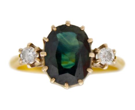 An Australian bi-colour sapphire and diamond 18k gold ring. The oval-shaped mixed-cut green/yellow sapphire is 2.5ct approx, 