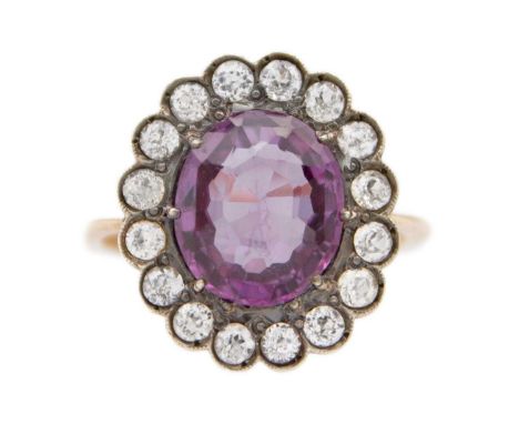 A high-purity rose gold colour-change synthetic sapphire dress ring. Tests 14k, the oval mixed-cut synthetic sapphire is 11mm