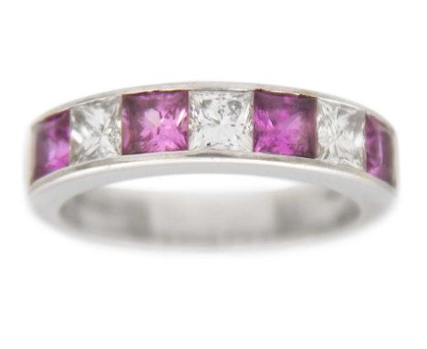 A pink sapphire and diamond channel set 18k white gold band ring. Four princess-cut sapphires with four white diamonds, 3mm x