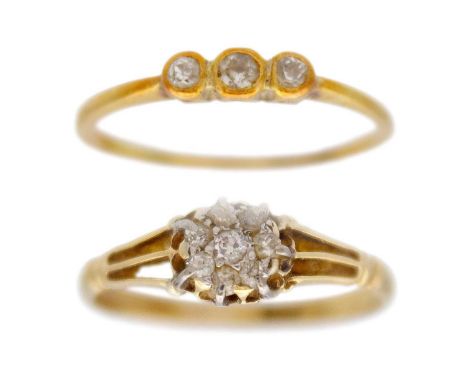 Two 18k diamond set rings. One is a three-stone ring with three small graduated diamonds in a collet setting, stamped 18ct &a