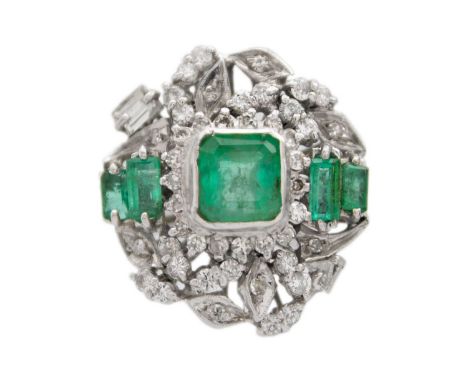 A white gold diamond and emerald set ballerina ring. The principal square emerald-cut emerald is 7mm x 7mm, surrounded by a d