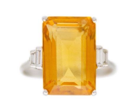 An orange citrine and diamonds 18k white gold dress ring. A rectangular-shaped emerald-cut citrine is 14mm x 9mm, set with tw