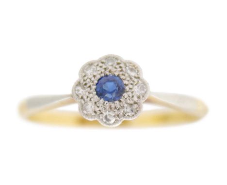 An antique 18k gold cornflower blue sapphire diamond daisy ring. Natural blue sapphire, 2mm diameter, surrounded by eight rou