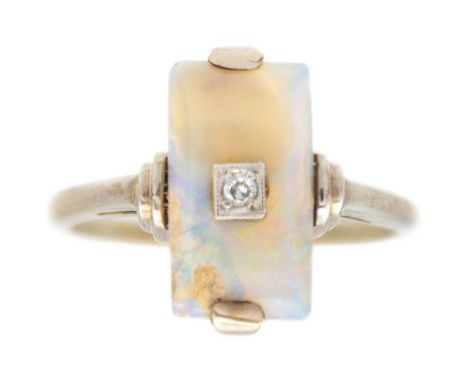 An Art Deco opal and diamond 9k white gold ring. The rectangular-shaped opal cabochon is 13mm x 8mm, round white diamond, 2mm