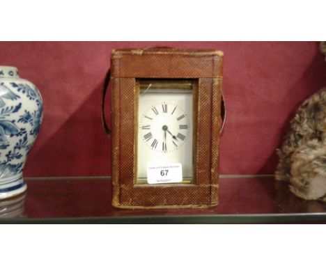 A late 19th / early 20th Century brass cased carriage clock contained in leather travelling case 