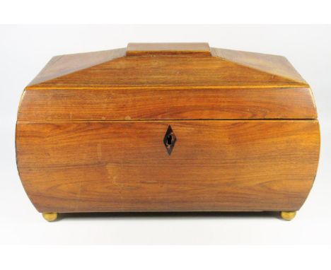 A REGENCY ROSEWOOD TEA CADDY OF ROUNDED RECTANGULAR FORM WITH INLAID BOXWOOD STRINGING, THE HINGED COVER DISCLOSING TWO HINGE