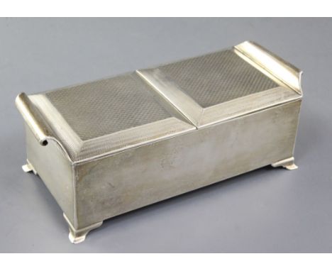 A stylish George V silver double lidded cigarette box, the engine turned lids with scroll handles, Henry Matthews, Birmingham