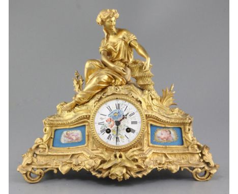 A Louis XV style gilt bronze 8 day mantel clock with Sevres style inset panels