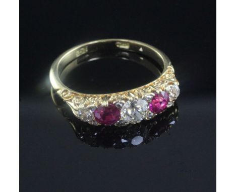 A 20th century 18ct gold and graduated five stone ruby and diamond half hoop ring, size Q.