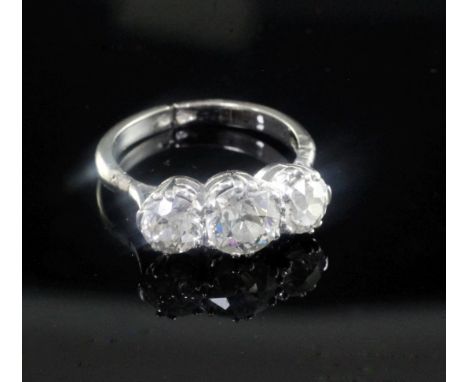 A mid 20th century white and three stone diamond ring, the adjustable shank with hinged shoulders and a total estimated diamo