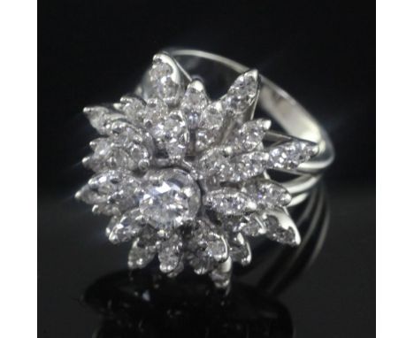 A 14ct white gold and diamond "snowflake" cluster dress ring, with an approximately estimated total diamond weight of 1.50cts