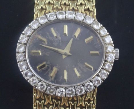 A lady's 18ct gold Piaget manual wind dress wrist watch with diamond set bezel, the oval dial with baton numerals, on integra