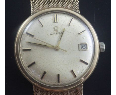 A gentleman's 1960's 9ct gold Omega manual wind wrist watch, with baton numerals and date aperture, movement c.611, on integr