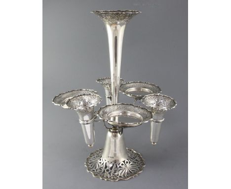 A George V silver epergne by Goldsmiths & Silversmiths Co Ltd, with central trumpet shaped vase and six removeable receivers 