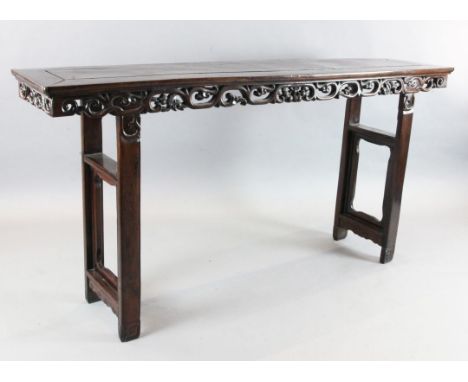 A Chinese rosewood (hongmu) altar table, late 19th century, with pierced scroll and fruit frieze, on end supports, W.6ft 10in