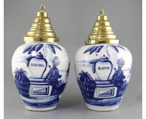 A near pair of Dutch delft blue and white tobacco jars and brass covers, late 18th century, the ovoid bodies painted with an 