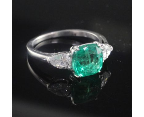 A platinum and iridium, three stone Columbian emerald and diamond ring, the 2.22ct square cushion cut emerald with accompanyi