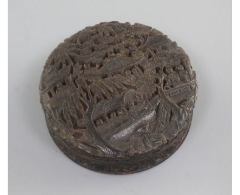 A 19th century Chinese tortoiseshell snuff box, carved in relief with figures in boats, pagodas and trees, 3in.