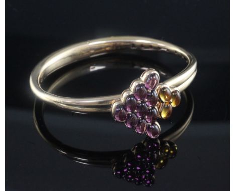 A 20th century French Maubusson 18ct gold and gem set hinged bangle, set with cabochon stones, signed and numbered F2186.