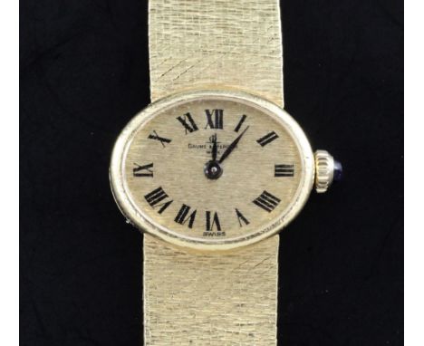 A lady's 1970's 18ct gold Baume & Mercier manual wind wrist watch, with oval Roman dial, on textured integral 18ct gold brace