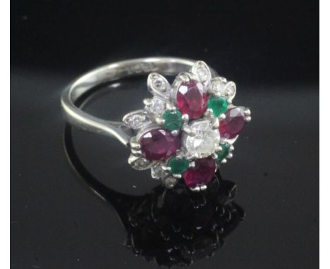 An 18ct white gold, ruby, emerald and diamond cluster ring, size L.